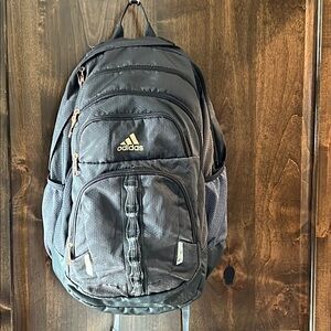 Adidas Prime full size backpack. 5 zipper compartments. Mesh pockets on side
